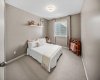 A comfortable secondary bedroom with neutral finishes and generous floor space.
