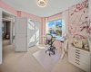 A bright front bedroom currently arranged as a creative home office.