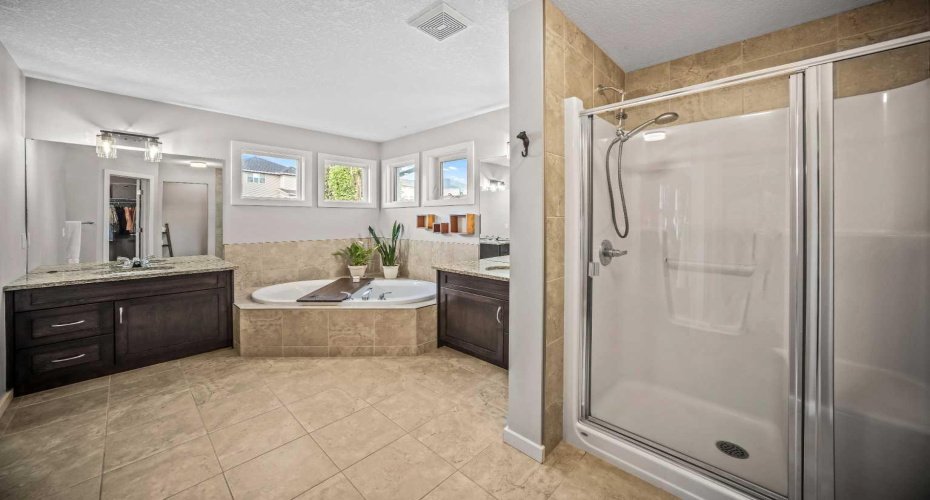 A separate shower complements the large tub and dual vanity layout.