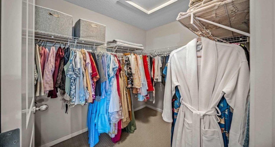 A generous walk in closet provides abundant hanging and storage space.