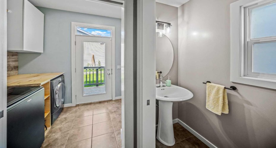 A convenient main floor powder room sits beside the laundry and rear entry.
