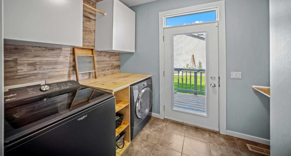 The laundry room includes storage, workspace and direct access to the backyard.