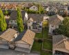 Aerial view highlights the detached garage, additional parking pad, backyard and surrounding neighbourhood.