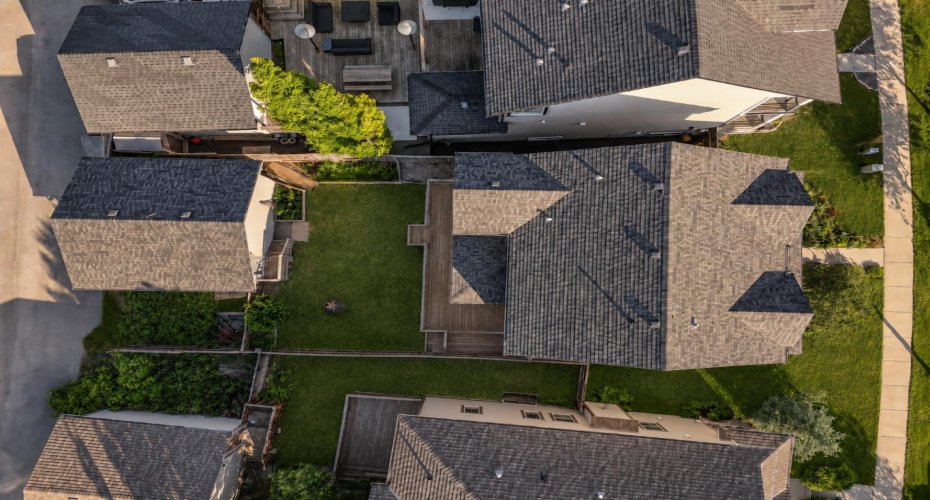 Aerial view highlighting the detached garage, spacious backyard and convenient rear parking pad.