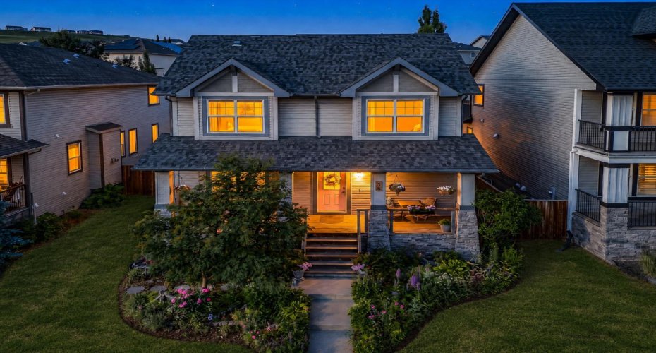 A final twilight exterior captures the warmth and welcoming character of the home.