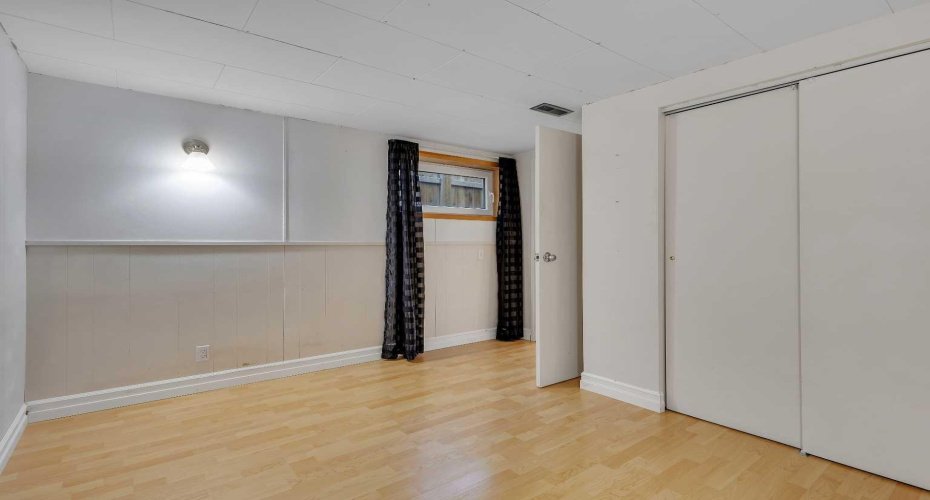 second bedroom in basement with egress window and sub-floor