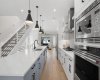 High end appliances and two toned cabinetry impress