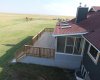 looking down from the upper deck onto the sun-room and lower deck. 4 skylights in the roof of the sun-room.