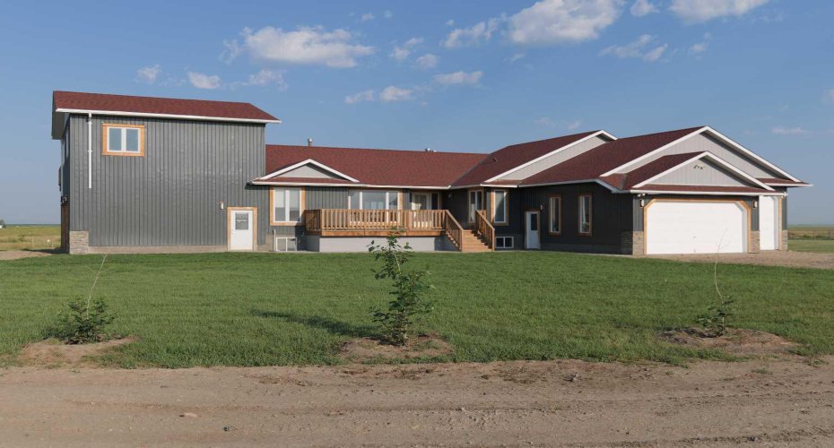East facing view of house. East facing over sized triple garage with access to the  basement