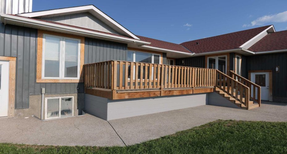 Extra wide exposed aggregate sidewalks. Windows have been trimmed out with western yellow pine.